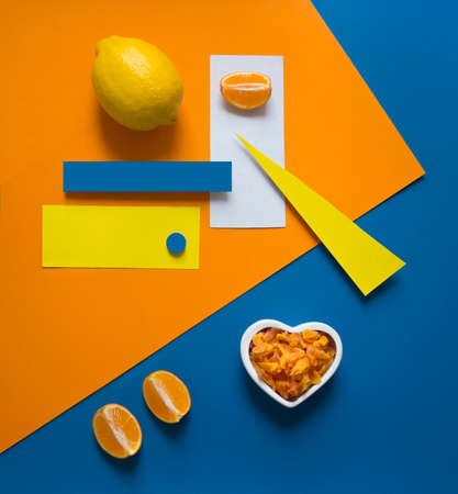 lemon orange on a bright background blue yellow orange triangle circle rectangle geometry heart dried fruits candied fruitsの写真素材