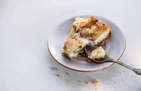 plate with apple pie and spoon on white tableの写真素材