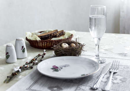 on the table napkin with a plate vegetable stew green onion glass fork knife and willow branches salt pepper sauceの写真素材