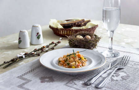 on the table napkin with a plate vegetable stew green onion glass fork knife and willow branches salt pepper sauceの写真素材