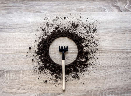 wooden background concept earth piled circle dish rake fork texture landing center spring horizontalの写真素材