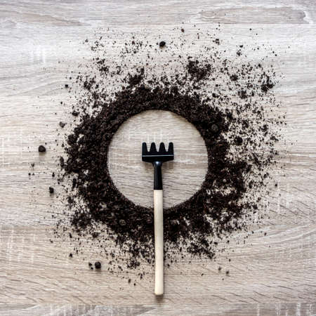wooden background concept earth piled circle dish rake fork texture landing centerの写真素材