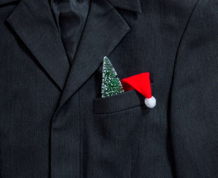 men's dark jacket in small stripes collar pocket sleeve in his pocket Christmas tree and cap red Santa Clausの写真素材