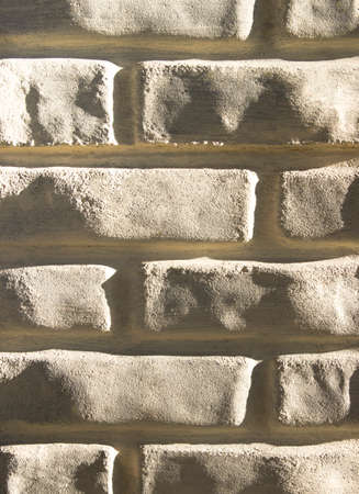 background texture light brick wall close-up brick sliding light verticalの写真素材