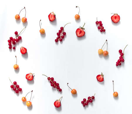 on a white background red currant pattern twigs and strawberry berries half cherry couple inscription place summer copy spaceの写真素材