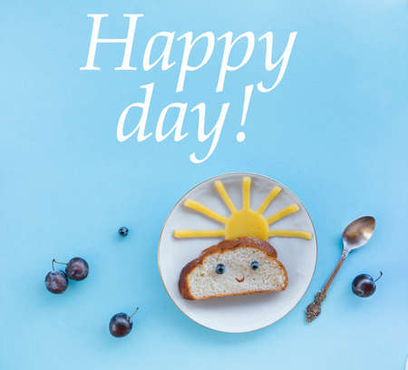 on a blue background breakfast morning sun cloud sky rays rays cute sandwich healthy food berries blueberries plum bread cheese plate spoon servingの写真素材