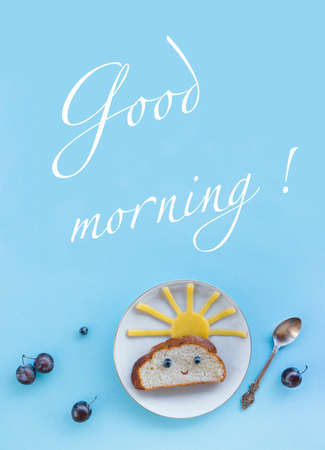 on a blue background breakfast morning sun cloud sky rays rays cute sandwich healthy food berries blueberries plum bread cheese plate spoon servingの写真素材