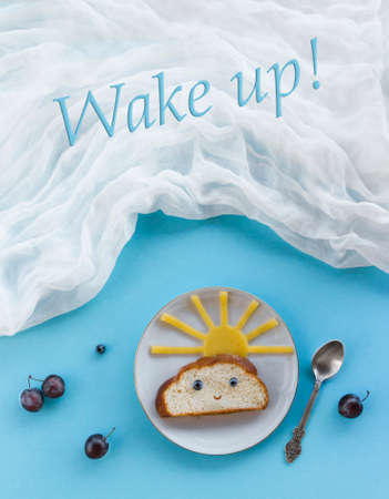 on blue background breakfast morning sun cloud sky rays joy cute sandwich healthy food berries blueberry plum bread cheese plate spoon serving napkinの写真素材