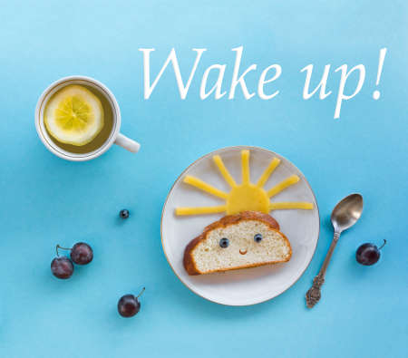 on blue background breakfast morning sun cloud sky rays joy cute sandwich healthy food berries blueberry plum bread cheese plate spoon serving napkin cup tea drinkの写真素材