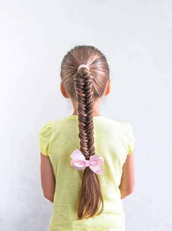 on white background girl with beautiful braid braid French hair weaving holiday hair ornament hair longの写真素材