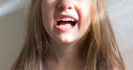 on white background, smiling girl showing teethの写真素材