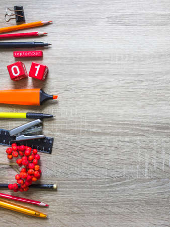 on a wooden background stationery note pad pencil ashberry autumn calendar cubesの写真素材