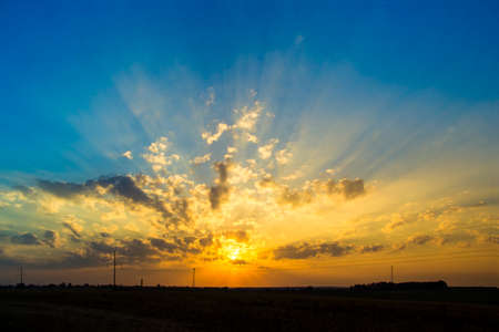 sunset dawn sun rays over the city sky