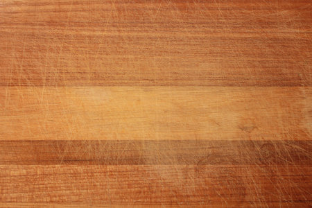 Wood texture in scratches. The texture of the wood is dark orange in scratches. The texture of the wood cutting Board with a lot of scratches from the knife.の写真素材
