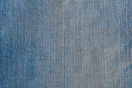 Perspective and closeup view to abstract space of empty blue natural clean denim texture for the traditional business background in cold bright colors with diagonal shift tilt lines and stitches.の写真素材