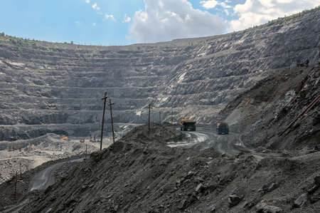 big yellow mining trucks at worksite in opencast mineの写真素材