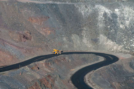 heavy truck in open cast mine transporting iron ore