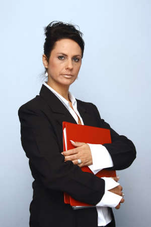 Business executive holding a red fileの写真素材