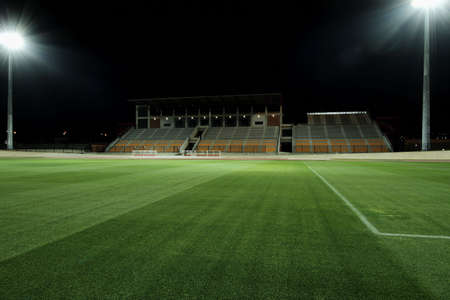 sports field being lit by floodlightsの写真素材