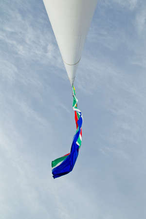 An upward view of a South African flag flying at half mast の写真素材