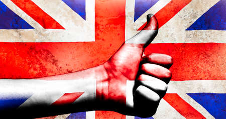 Thumbs up on a British flag with a grunge texture behindの写真素材
