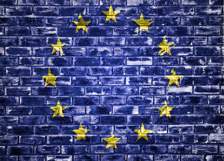 European Union flag placed on a textured wall to be used as a background or wallpaperの写真素材