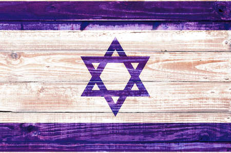 faded Israeli flag on a rough wooden texture