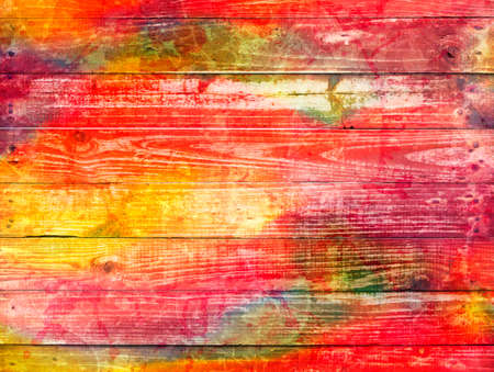 bright mixture of colours on a wooden textured backgroundの写真素材