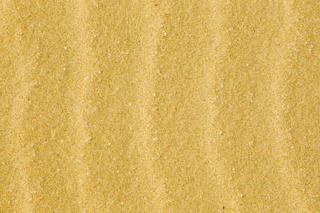 waves in beach sand caused by strong winds and erosion
