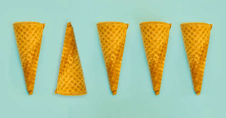five empty brittle sugar cones lying on a blue backgroundの写真素材