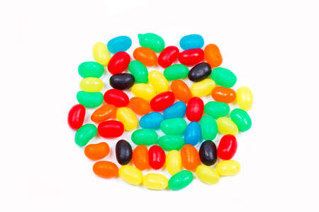small jelly beans in different bright colours on a white background