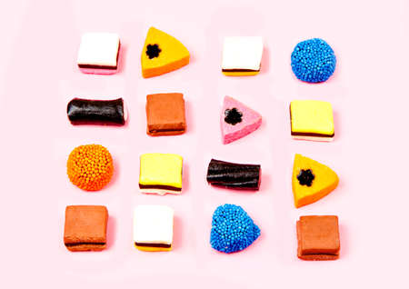 liquorice candy made of different bright colours on a pink backgroundの写真素材