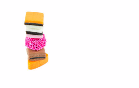 liquorice made of difference colours and shapes stacked on a white backgroundの写真素材