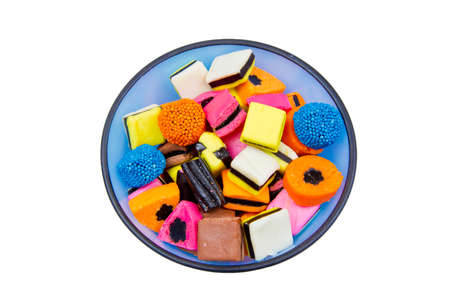 Tasty Liquorice all sorts in a blue bowl on a white backgroundの写真素材