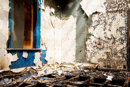 inside of a grungy old abandoned building with peeling paint