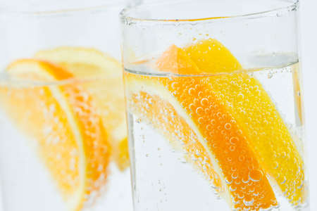 tall glasses of lemon and orange with ice to refresh on a hot summer dayの写真素材