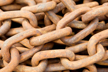 Close up view of a large pile of rusted anchor chains 
