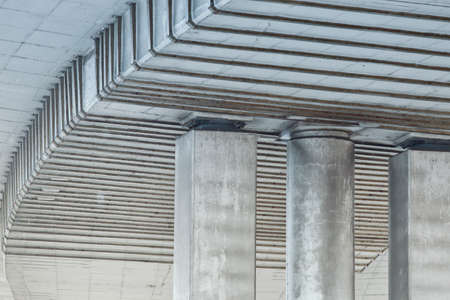 large supporting beams made of concrete and poles of a flyover highwayの写真素材