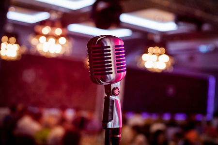 Microphone. Retro microphone. A microphone on stage. A pub. Bar. Restaurant. Classic. Evening. Night show. European restaurant. European bar. American restaurant. American bar.の写真素材