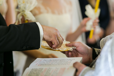 newlyweds exchange rings, wedding rings on a wedding ceremony in the church,wedding ceremony, glansの写真素材