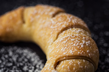 tasty fresh croissants sprinkled with powdered sugar.Delicious continental breakfast with fresh flaky croissants,close up on the croissants.croissant bread on buffet line.Fresh homemade croissantsの写真素材