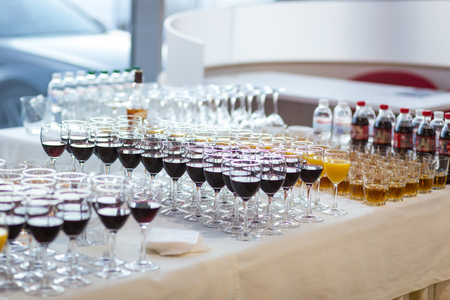 glasses with juice, champagne glasses, glasses with wine,catering banquet table, catering, stemware,red wine,whiskeyの写真素材