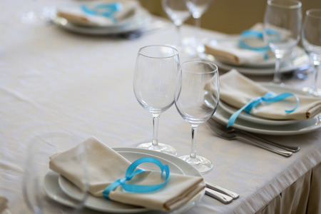 table setting,restaurant serving,restaurant interior,empty glasses on the white table, A row of...