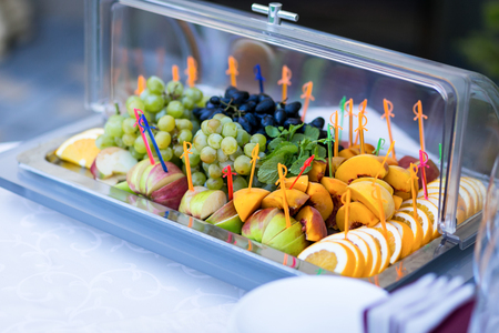 fruit on a plate, grapes, plums,orange,apple and peaches. Buffet, Cateringの写真素材