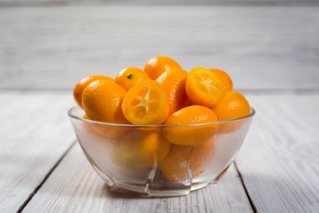 Kumquat in a plate,Raw Organic Orange Kumquats,Small oranges. Chinese orange. Oval oranges.Close upの写真素材