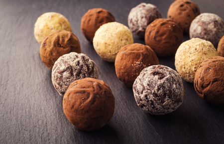Chocolate truffle,Truffle chocolate candies with cocoa powder.Chocolate candies collection.Assorted chocolate truffles with cocoa powder, coconut and chopped hazelnuts on a dessert plate.の写真素材