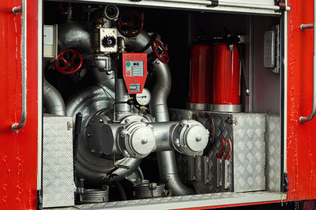 Compartment of rolled up fire hoses on a fireengine. Emergency safety. Protection, rescue from...