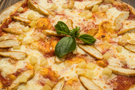 Pizza with chicken breast, pineapple and mozzarella cheeseの写真素材