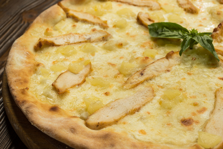 Pizza with chicken breast, pineapple and mozzarella cheeseの写真素材