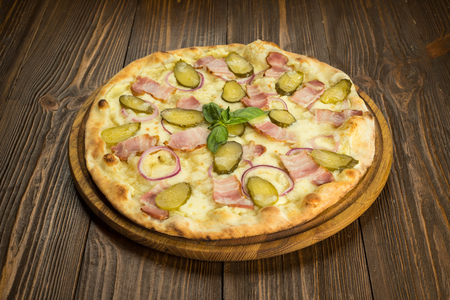 pizza with bacon and pickled cucumbersの写真素材